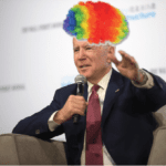 Biden speaking into a microphone wearing a clown wig