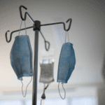 Disposable masks hanging from IV stand